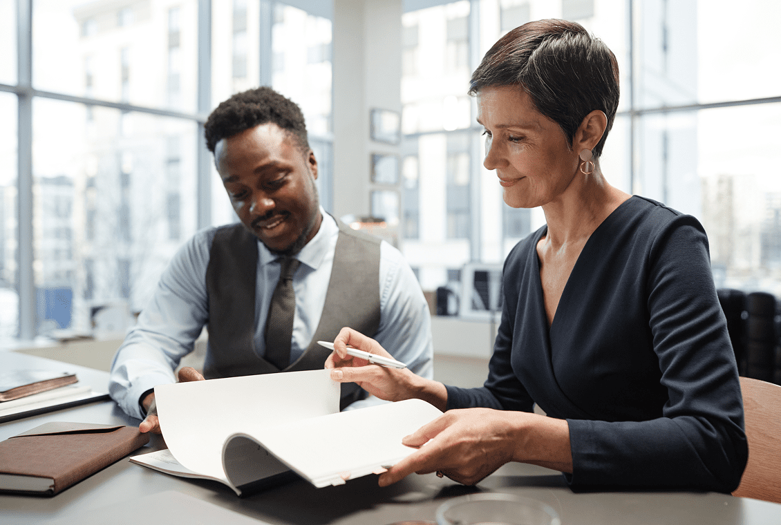 Professionals discussing paperwork together