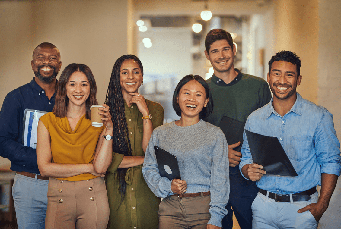 Diverse team standing together happily